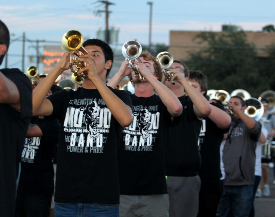 Sophomore Sunny Munoz and Senior Rayce Dorsey perform with the band during the Homecoming bonfire Sept. 24.