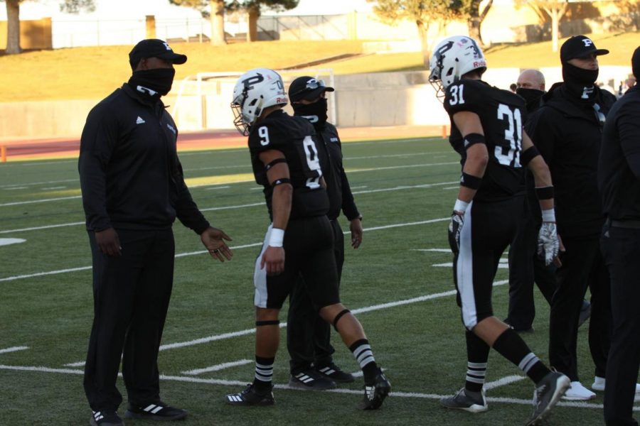 Coaches shake hands with the players as they head back into the locker room before the game.