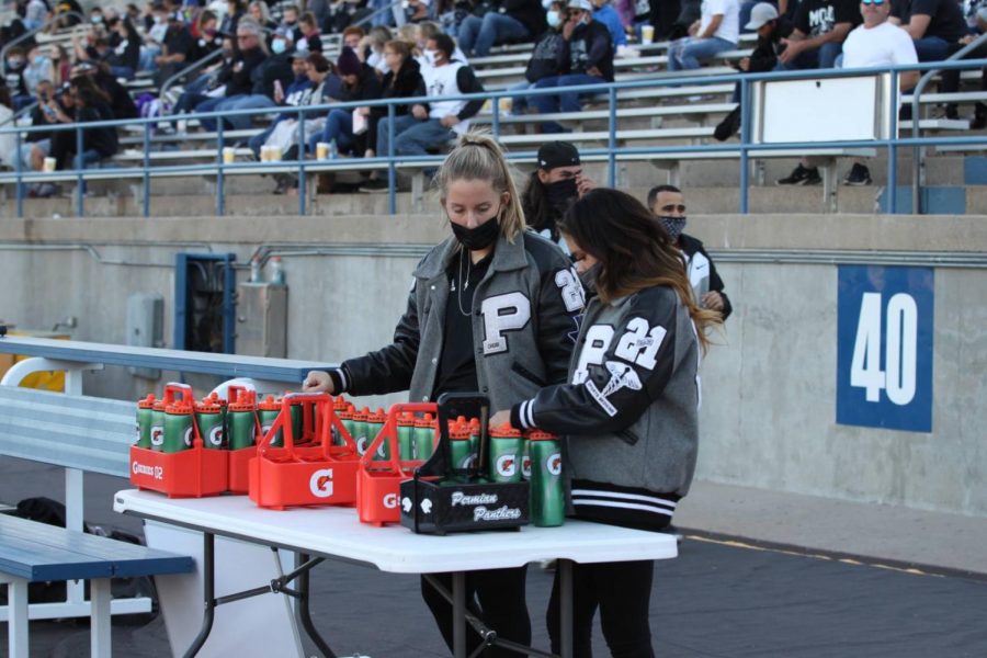 Trainers make sure all of the water bottles are filled before the Homecoming game. Permian would beat Midland Lee 55-44.