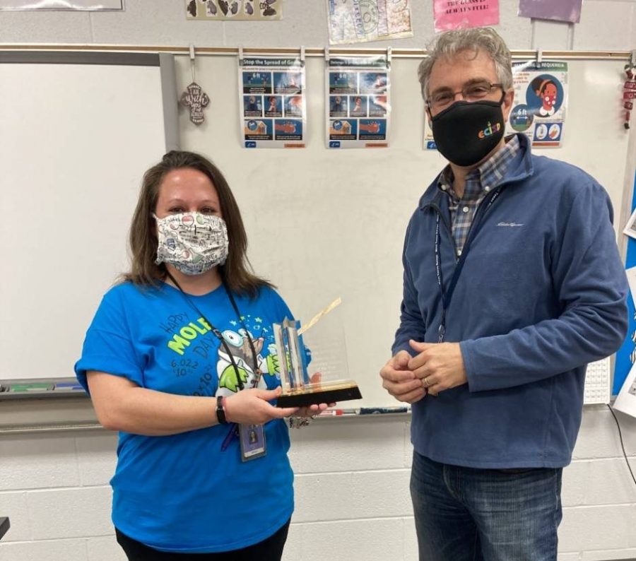 Chemistry teacher Dr. Rebecca Joy receives her award from Communications Director Mike Adkins. 